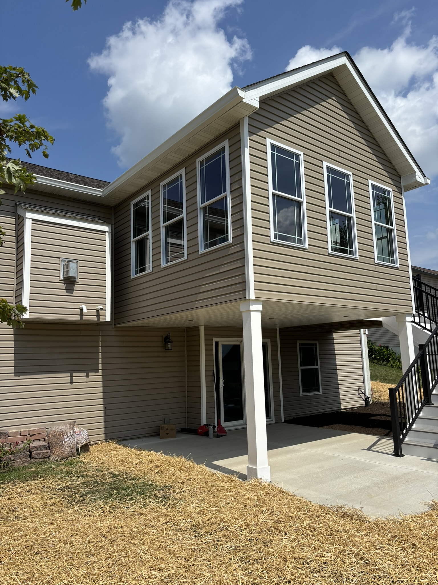 Completed home addition that matches the original house with consistent siding, windows, trim, and roofline
